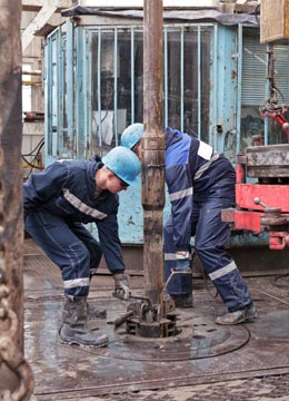 Roughnecks working in a drilling rig